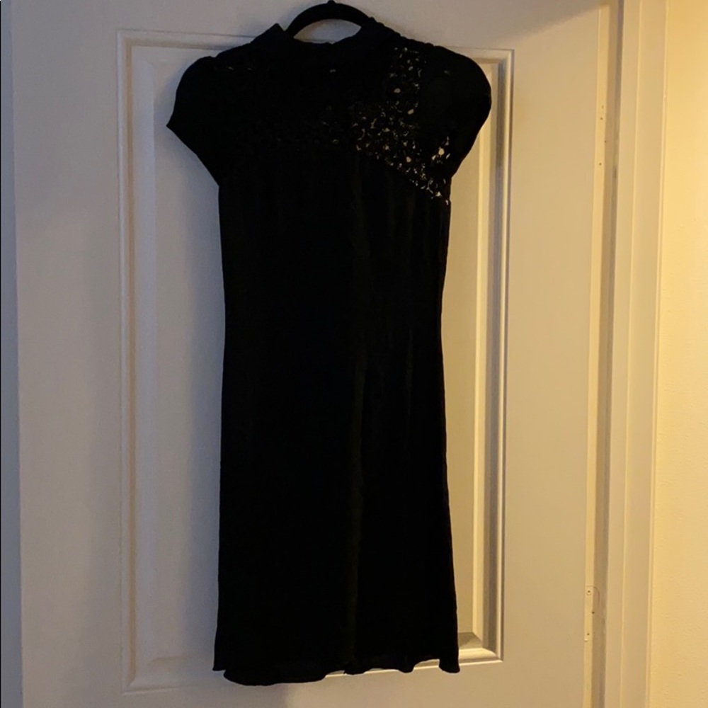 Fitted black dress with see-through top